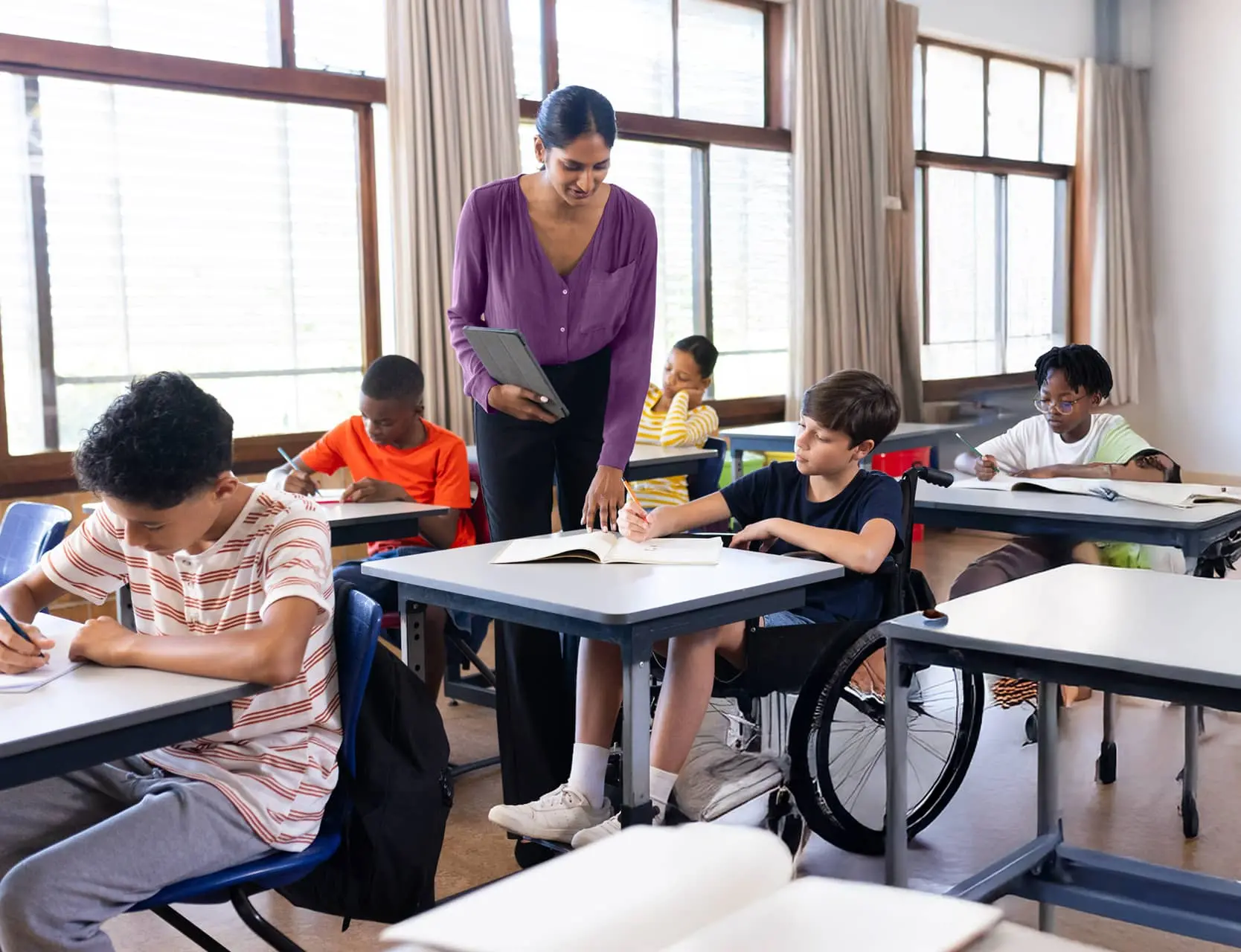 A teacher with a boy in a wheelchair